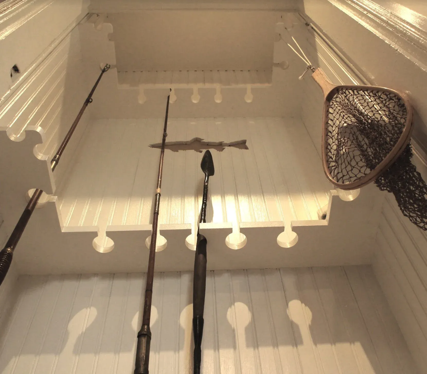 Antique fishing rods and net inside the Fishing Lodge